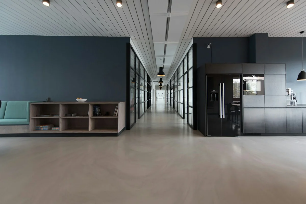 Illustrative office pantry and open workspace with fitted cabinets; not an available unit